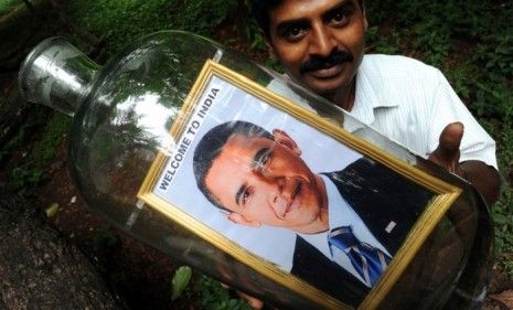 A Bangalore artist holds one of his Obama-in-a-bottle creations as India prepares for the President&amp;#039;s four-day visit.