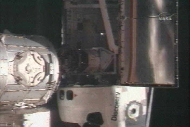 Shuttle Discovery Arrives at Space Station with Japanese Lab