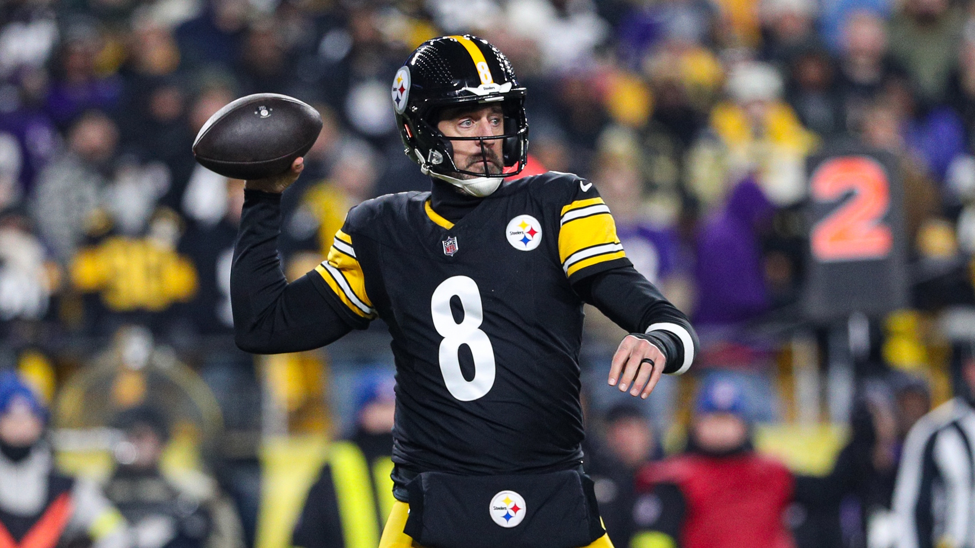 Pittsburgh Steelers quarterback Aaron Rodgers prepares to throw a pass during an NFL football game.