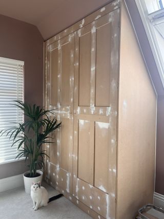 An IKEA pax wardrobe with mdf trim stuck onto the doors