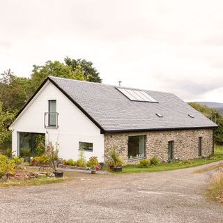 how to heat your home: solar panels attached to rural cottage images by douglas gibb