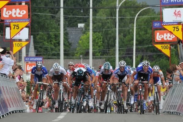 The peloton hurtles through the finishing chute.