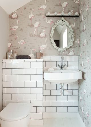 Sall white ensuite bathroom with grey flamingo Cole and Son wallpaper