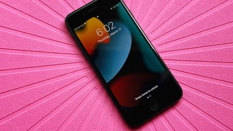 iPhone SE on a pink background