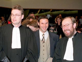 Belgian soccer player Jean-Marc Bosman, flanked by two of his lawyers Luc Misson (R) and Jean-Louis Dupont (L), smiles as the European Court of Justice rules 15 December 1995 that the transfer system of players between football clubs was illegal. The ruling of the European Court of Justice in December 1995 upheld the case brought by Jean-Marc Bosman against the European football authorities as a result of his failed transfer from a Belgian to a French club in 1990. The repercussions spread quickly through western European football as the European Union demanded that regulations concerning players' transfers and limitations on foreign players be amended almost immediately