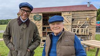 Jay Blades and Sir David Jason stood in front of a tool shed for David and Jay's Touring Toolshed
