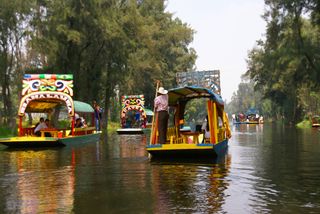The canals of Xochimilco, where tourists can rent brightly colored boats for parties and excursions, are built on the ruins of Tenochtitlan.