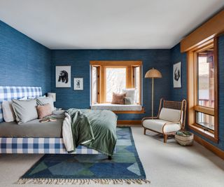 blue bedroom with window seat and checkered bedhead