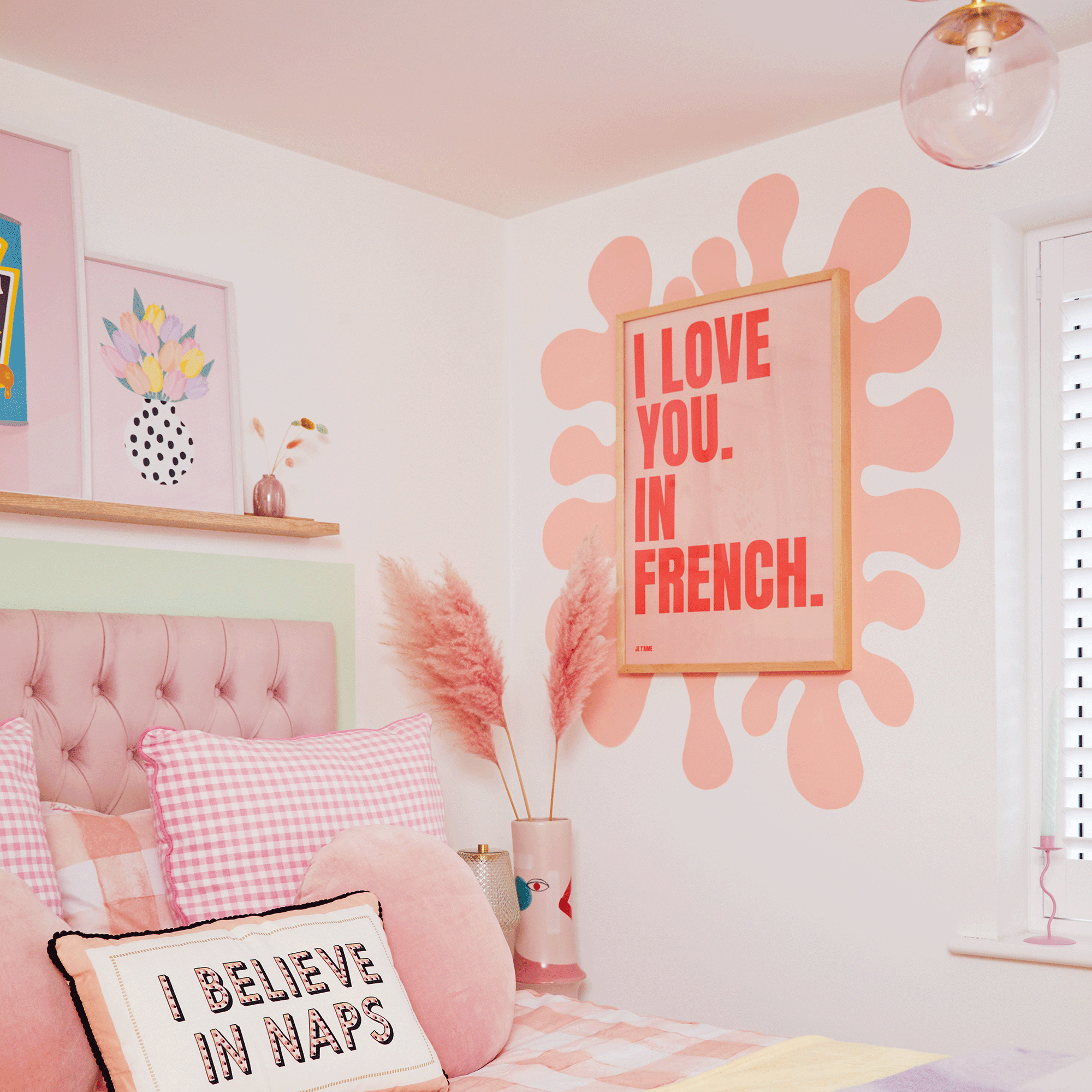 Pink bedroom with wall art surrounded by painted border