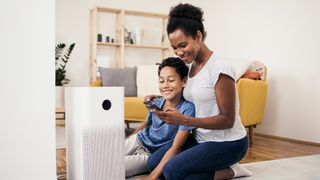 woman and her son using one of the best air purifiers to clean the air in their home