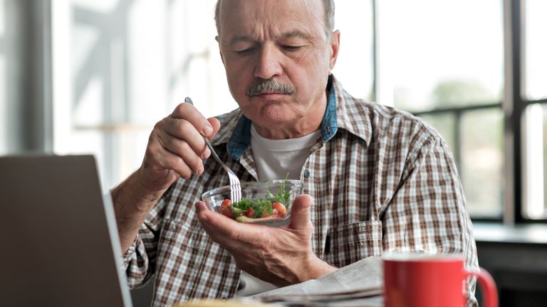 Man eating a salad for lunch