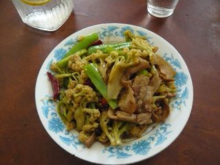 A plate of cauliflower Chinese food on a wooden table