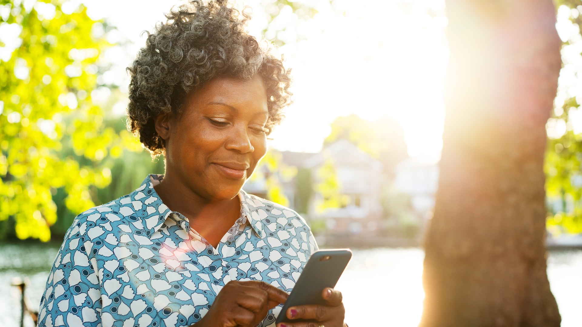 Woman looking at phone outdoors