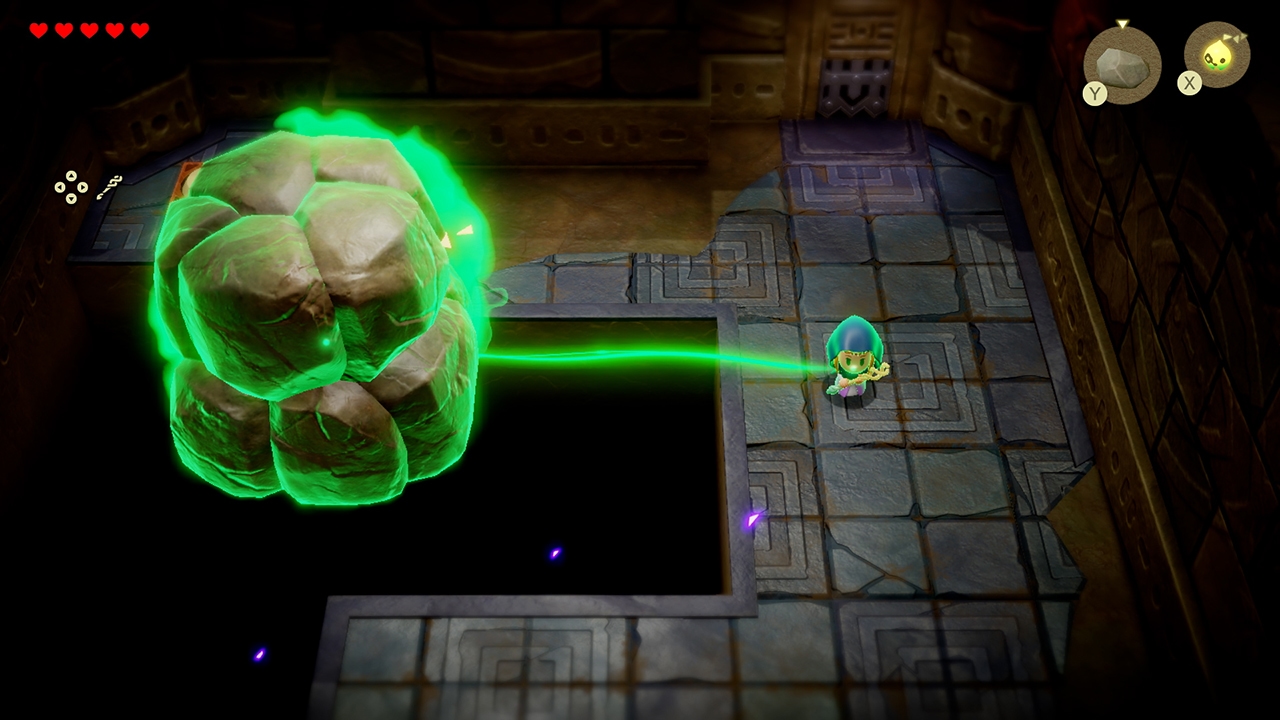 Deep within a dungeon, Zelda uses the power of Tri&amp;rsquo;s rod to bind and move a massive boulder across a dark pit.