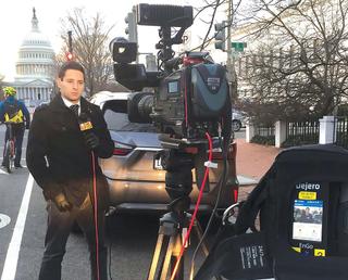 News reporter lit naturally with a single light on camera to supplement