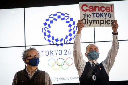 Protester in Tokyo with placard calling for Games cancellation