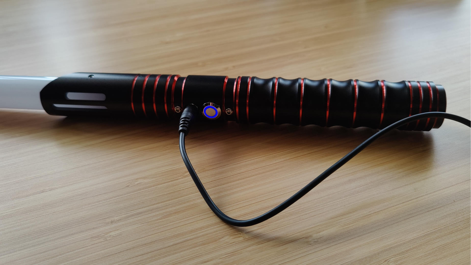 Encalife lightsaber charging using included cable.