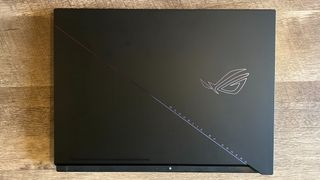 Asus ROG Zephyrus Duo 16 with closed lid on a wooden table
