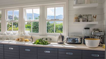 kitchen countertop with a coffee maker, blender, and kettle on it