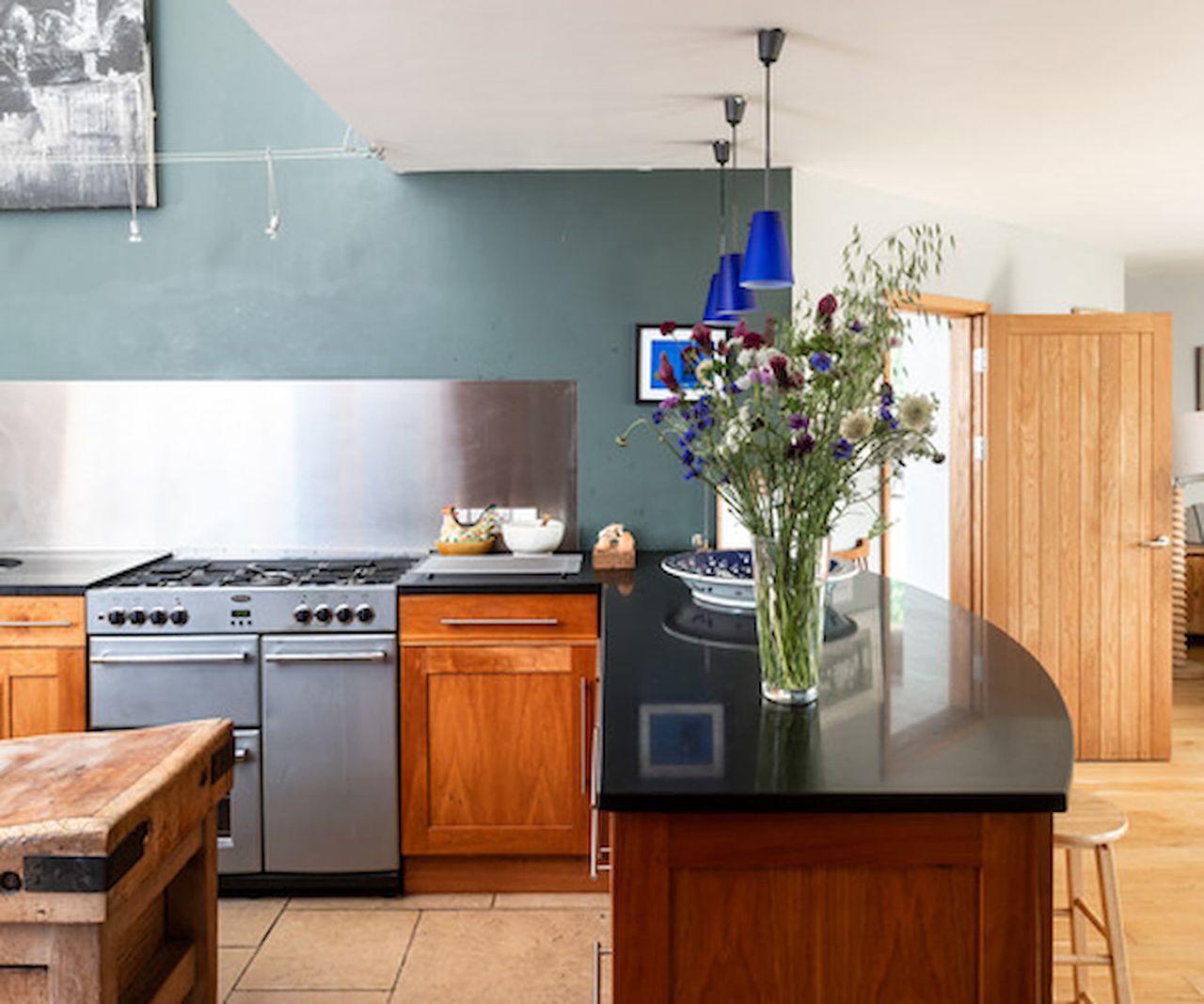 A kitchen with a kitchen island with an overhead rooflight