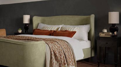 Feather & Black mattress on a green bed frame in a chic bedroom.