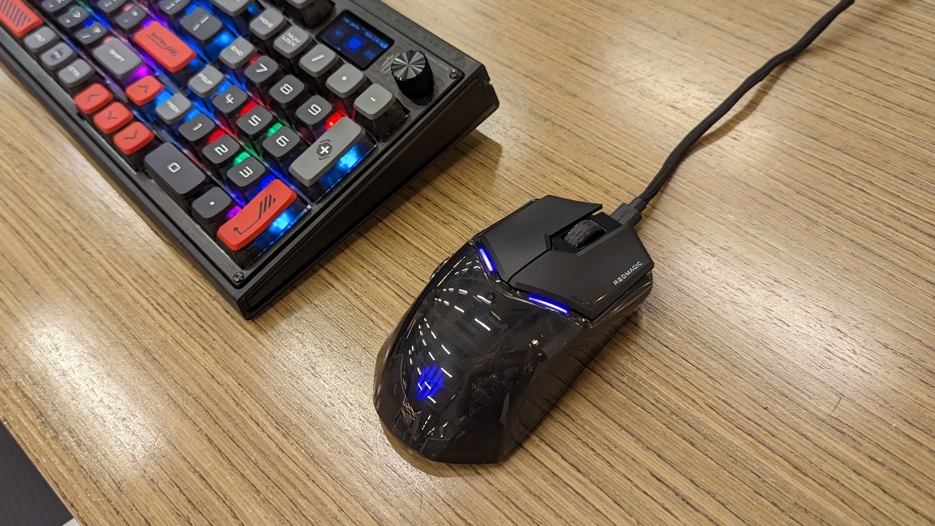 RedMagic Mouse and Mechanical Keyboard on a wooden desk.