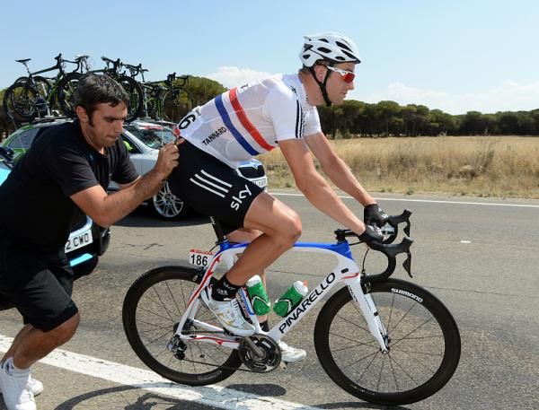Ian Stannard gets a push after a wheel change