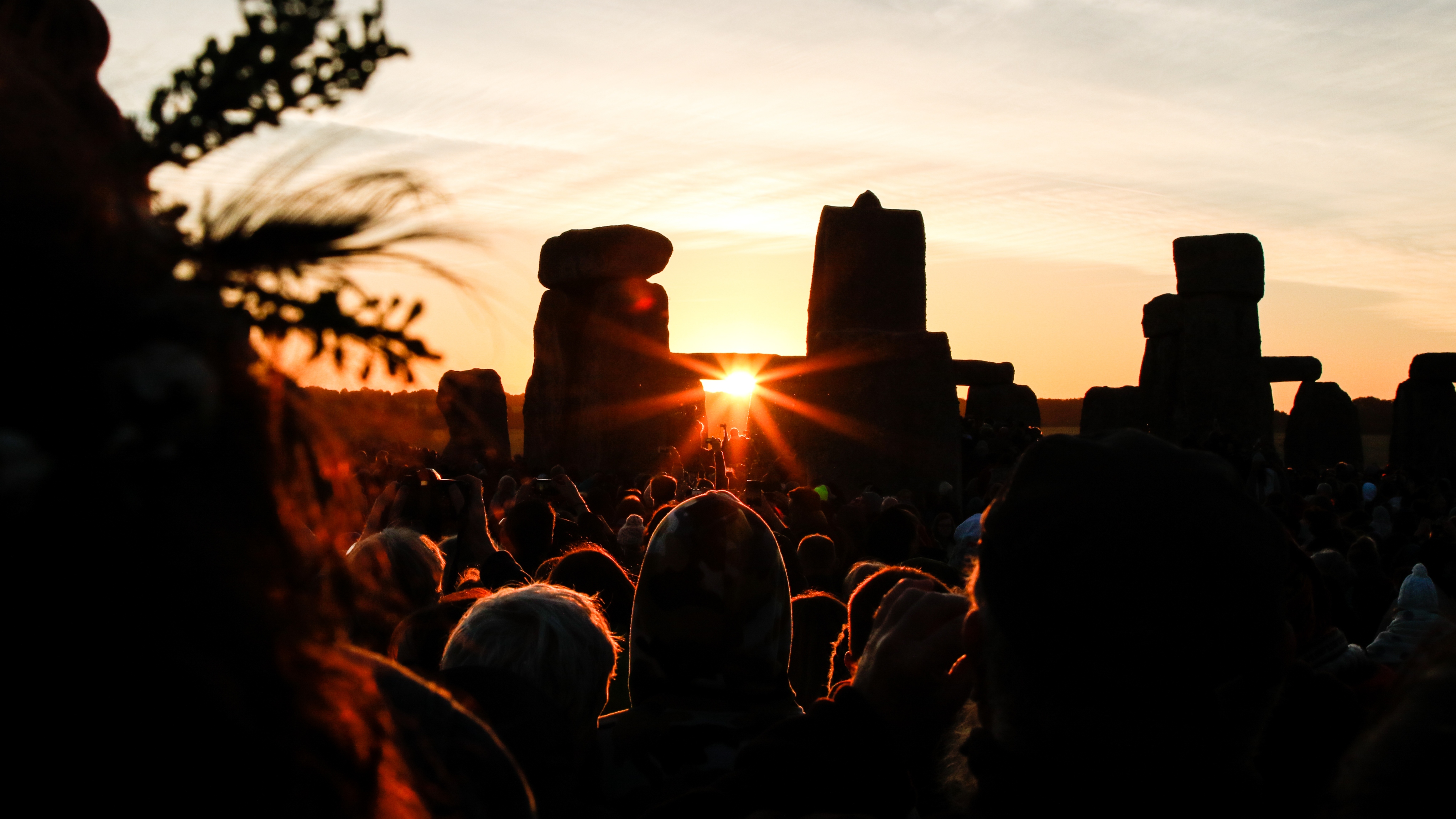 Crowds celebrating summer solstice and the dawn of the longest day of the year at Stonehenge on June 21, 2018