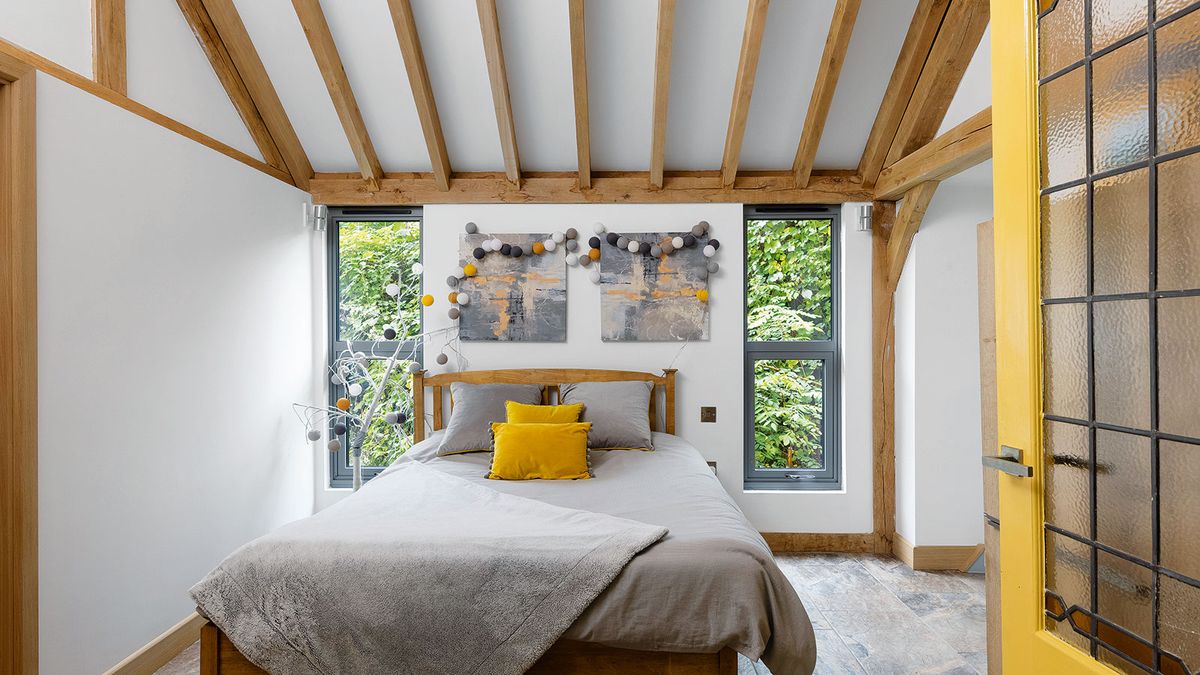 bedroom with vertical windows and yellow door