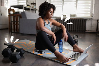 Woman at home on exercise mat, wondering if she can exercise with Covid-19