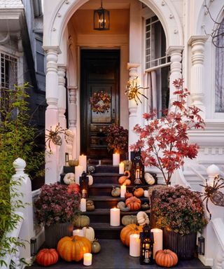 Porch decorated for Halloween with pumpkins and lanterns