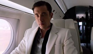 Andrew Koji sits brooding on a plane in Snake Eyes.