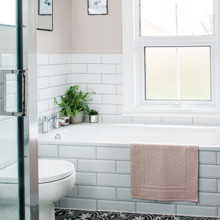 white metro tiles with grey grout in a white bathroom