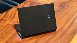 An Asus Zenbook Pro 16X OLED on a wooden table
