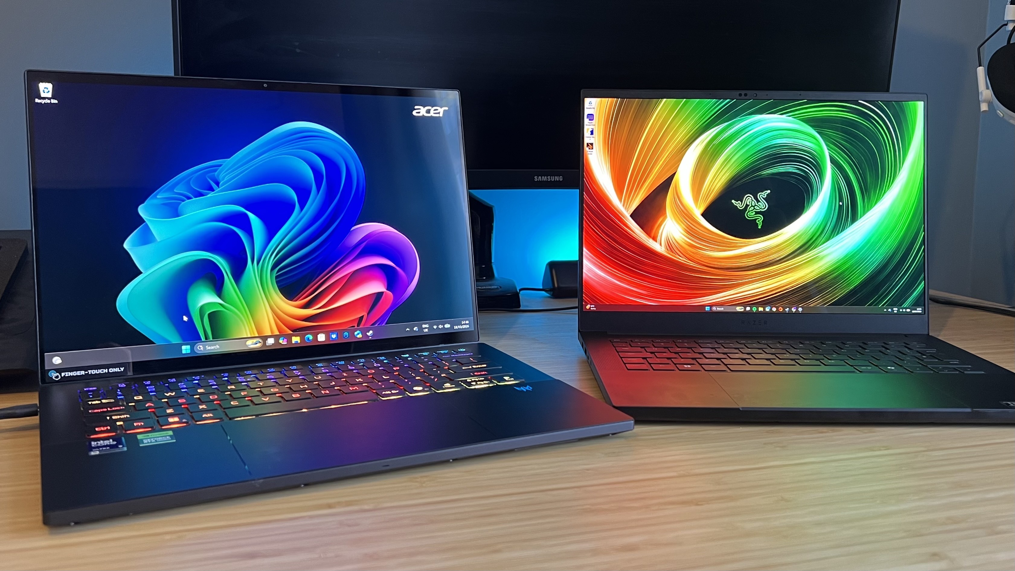 Razer Blade 14 and Acer Predator Triton 14 AI gaming laptops on a wooden desk