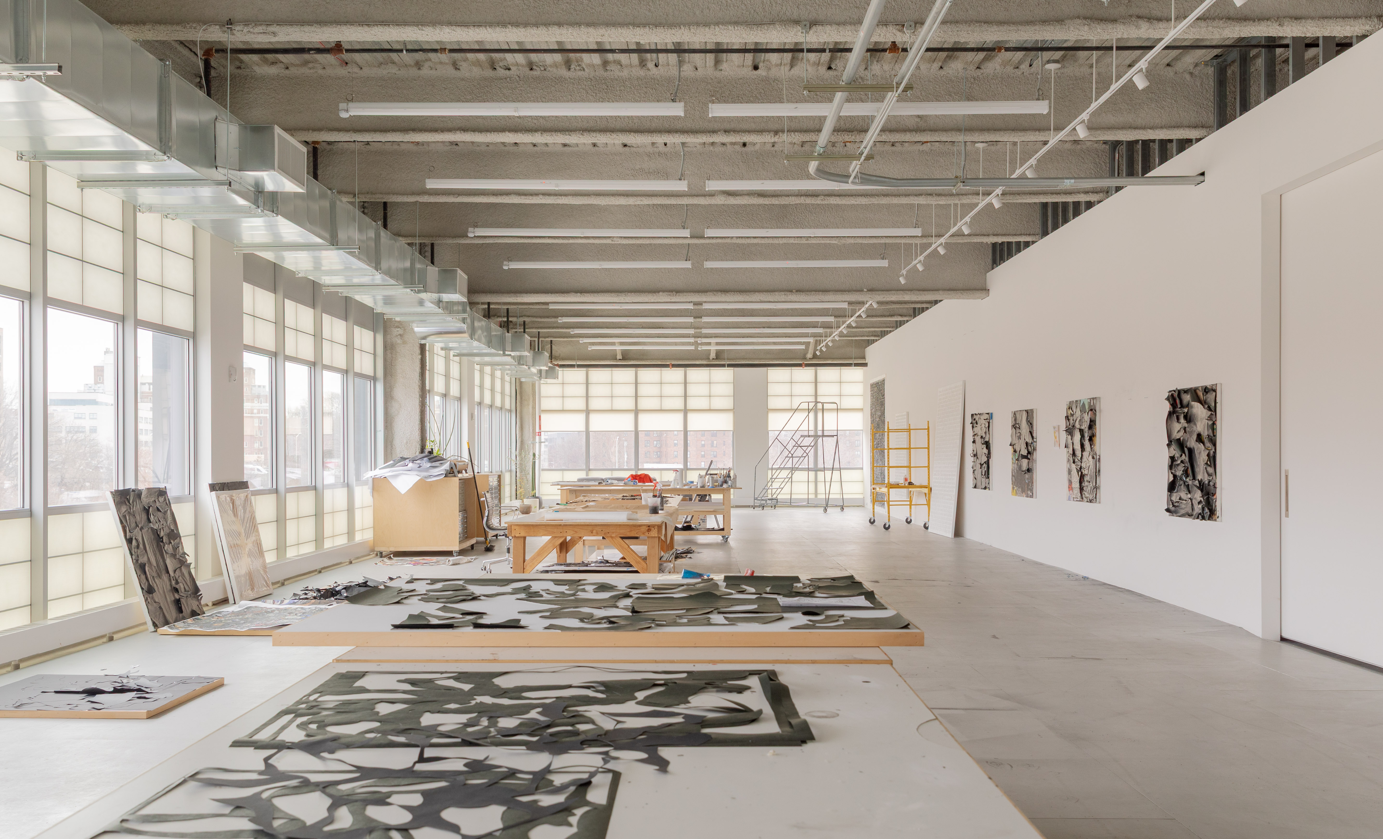 minimalist interior of artist Glenn Ligon's studio by Ravi Raj, with artworks and bespoke utilitarian furniture