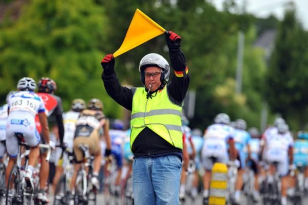 The signal men are a very important part of bike races in Belgium, the Netherlands and everywhere traffic islands are prevalent.