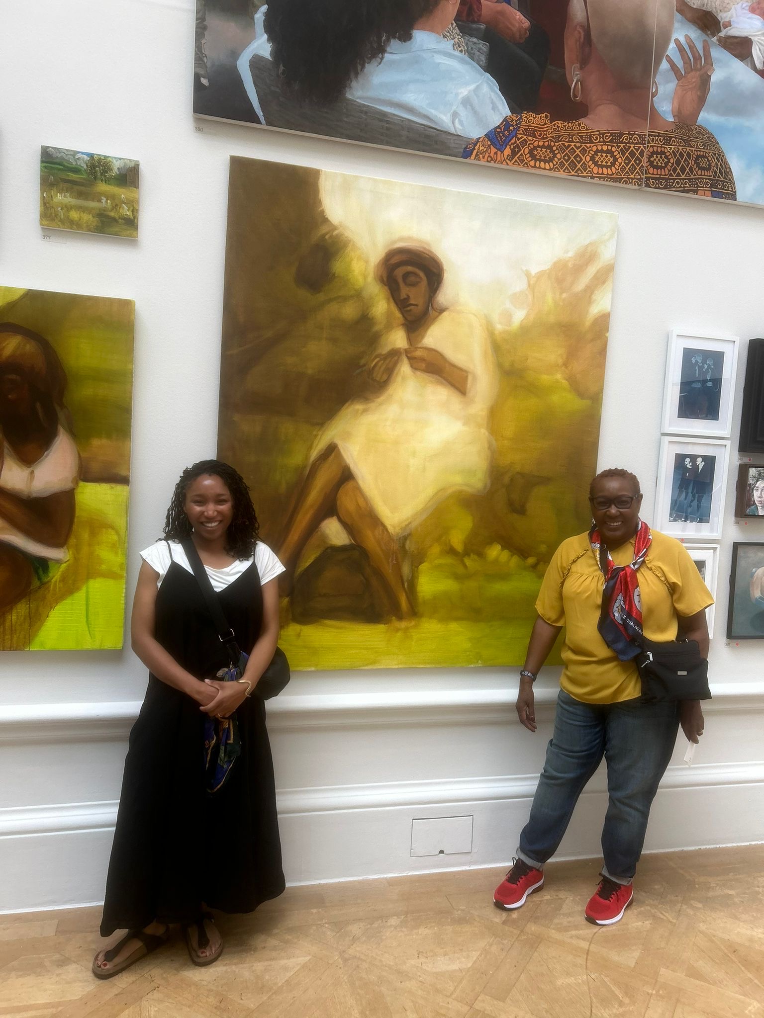 Sikelela Owen and her mother in front of her painting, 'Knitting'