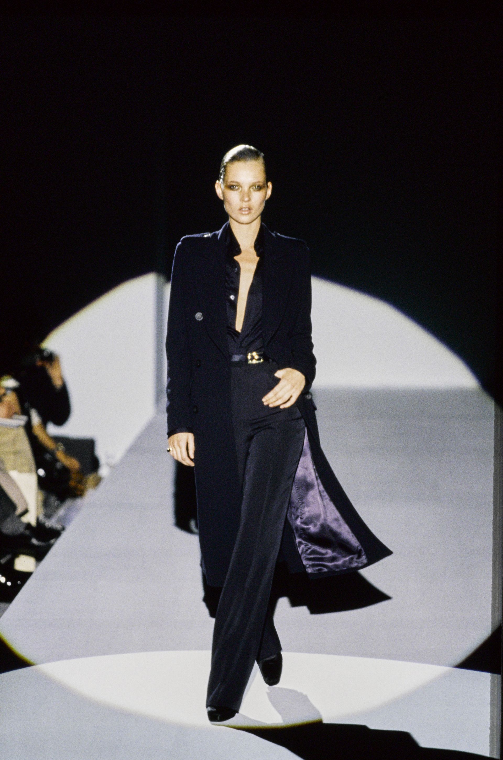 An image of Kate Moss wearing Tom Ford for Gucci cigarette trousers from 1996.
