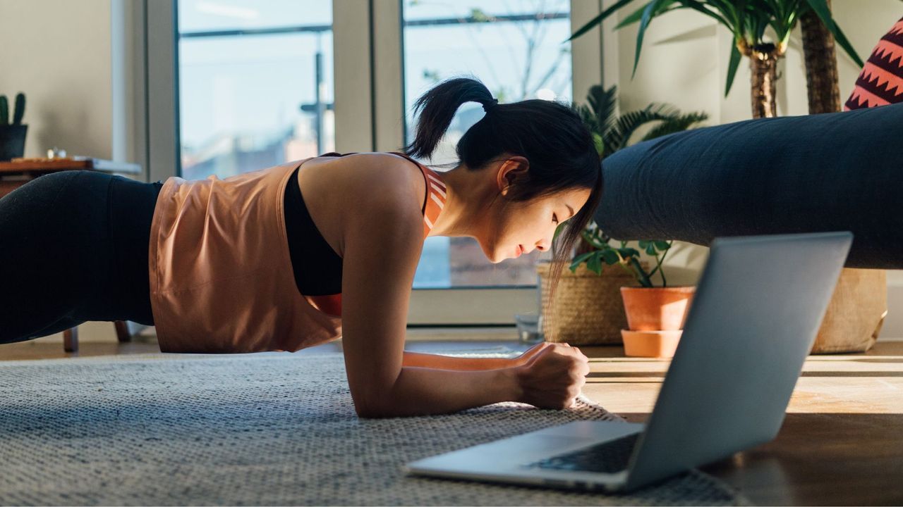 Home workouts for beginners: A woman doing a plank at home