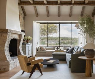 european looking living room with large windows and olive trees