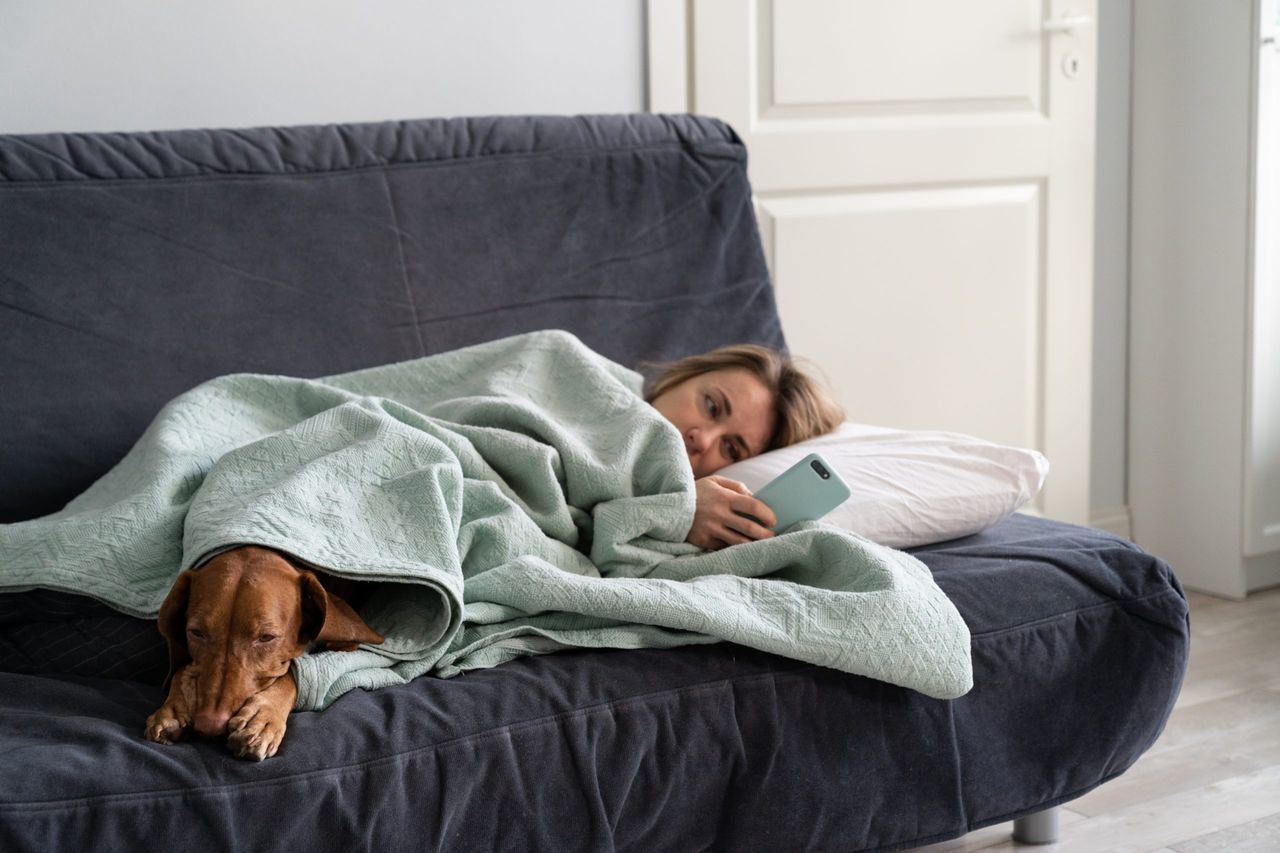 woman under heated blanket