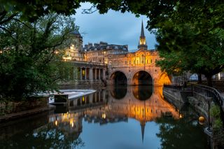 Pulteney Bridge in the River Avon at twilight, Bath, Somerset, England.