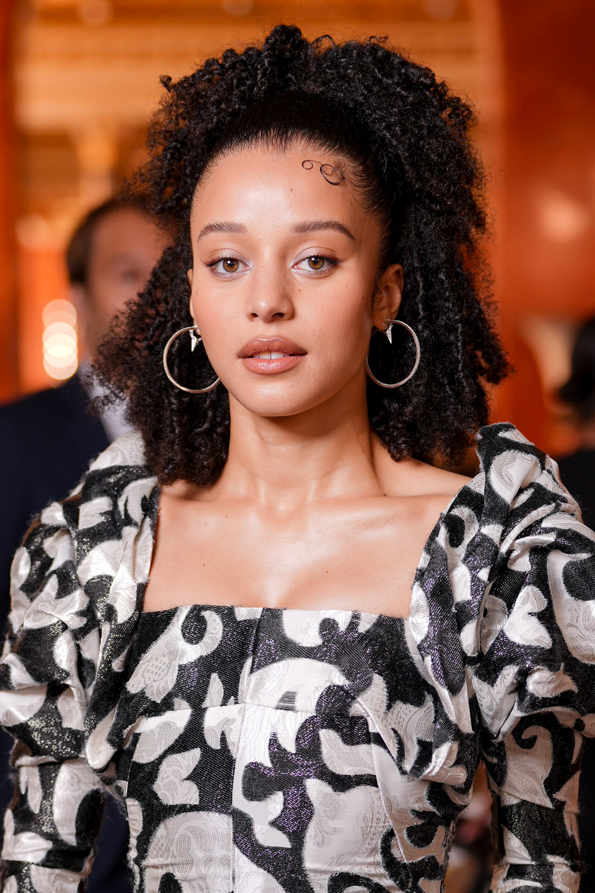 chase infiniti with a half-up, half-down curly style