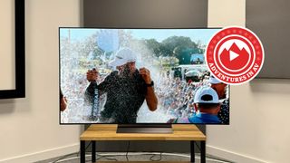 65-inch LG C4 TV on a wooden stand. A golfer is being sprayed with champagne on the screen.