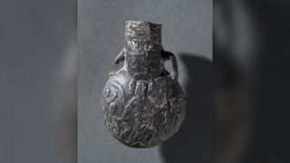 A lead pilgrim's flask dating to the Crusader Period (1099-1200). According to the Cleveland Museum of Art, "The flask was cast with images of the Church of the Holy Sepulcher and Christ's Descent into Limbo."