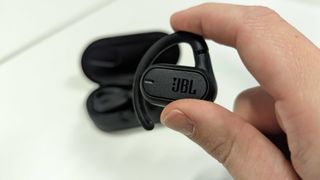 JBL Soundgear Sense in a hand, on white background
