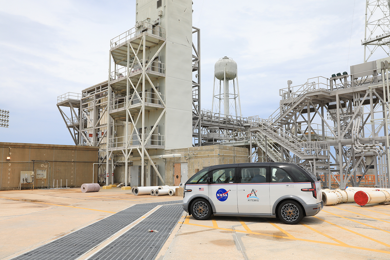 an electric minivan sits near the launch pad at kennedy space center in florida