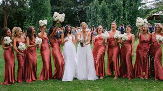 Post wedding picture of two brides and their bridesmaids