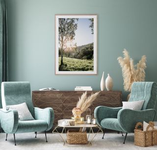 green living room with an art prints of fields and trees